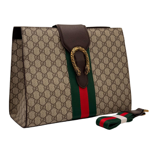 Designer handbag with distinctive pattern and strap on a light gray background