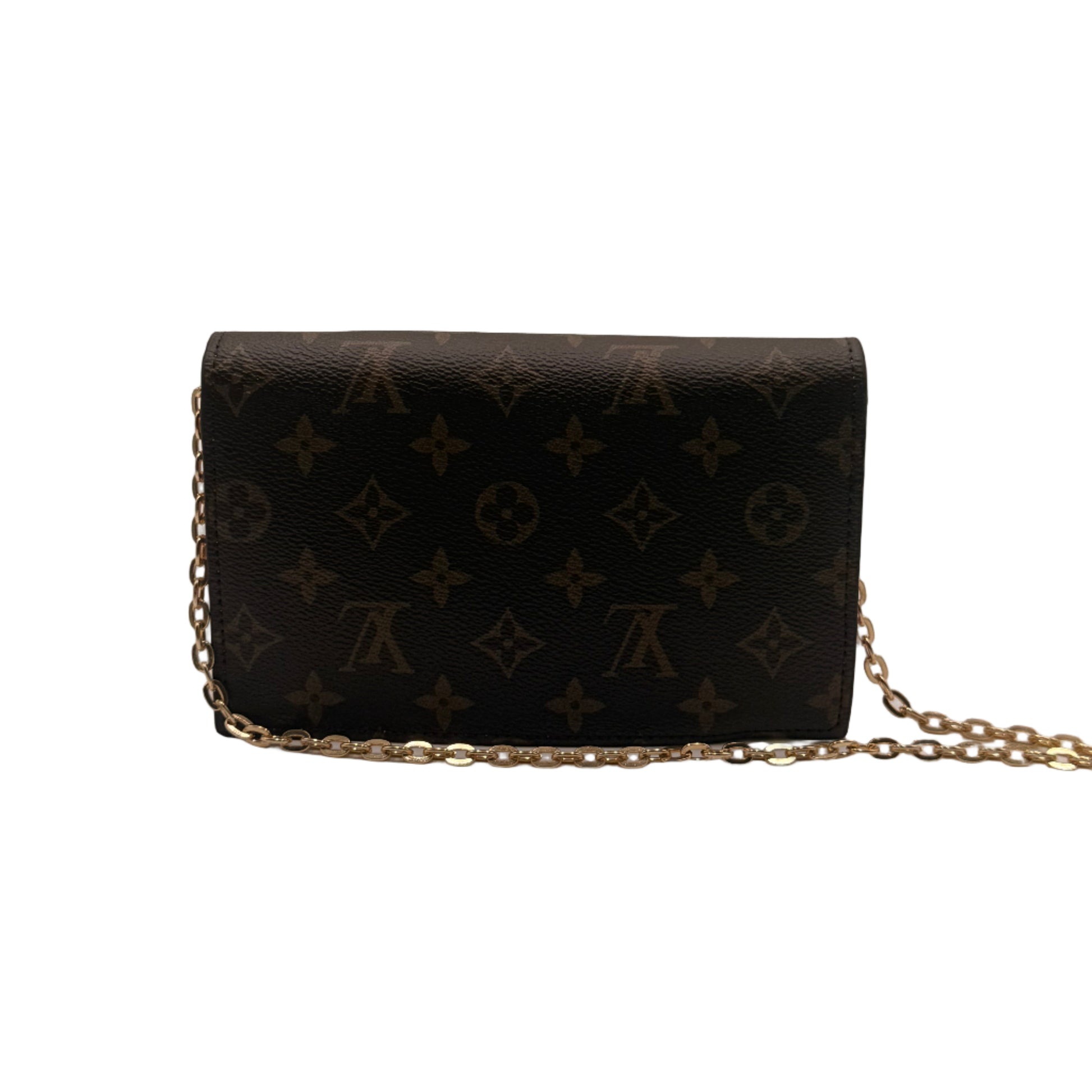 Black handbag with gold chain on a light gray background