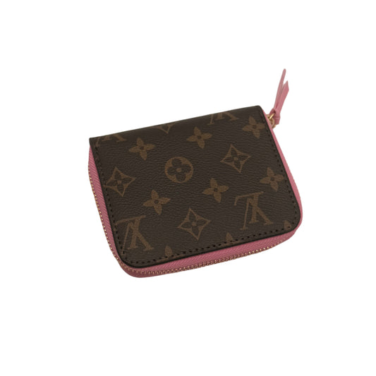 Louis Vuitton wallet with pink zipper on a light gray background