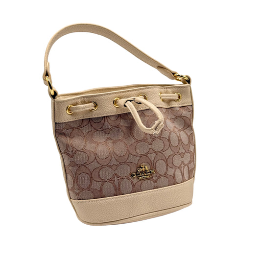 Designer handbag with patterned design on a light gray background