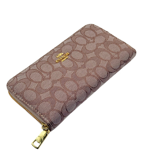 Patterned wallet with gold zipper on a light gray background