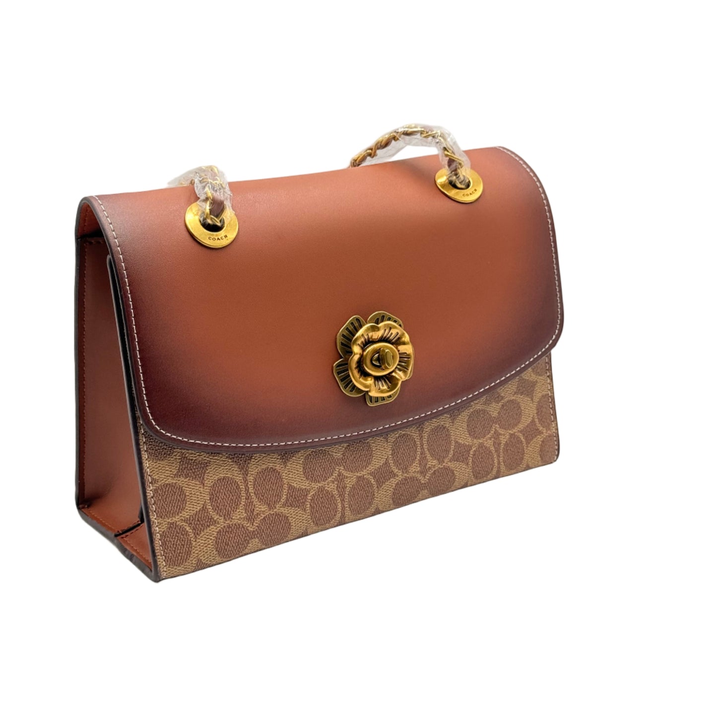 Brown leather handbag with gold clasp on a light gray background