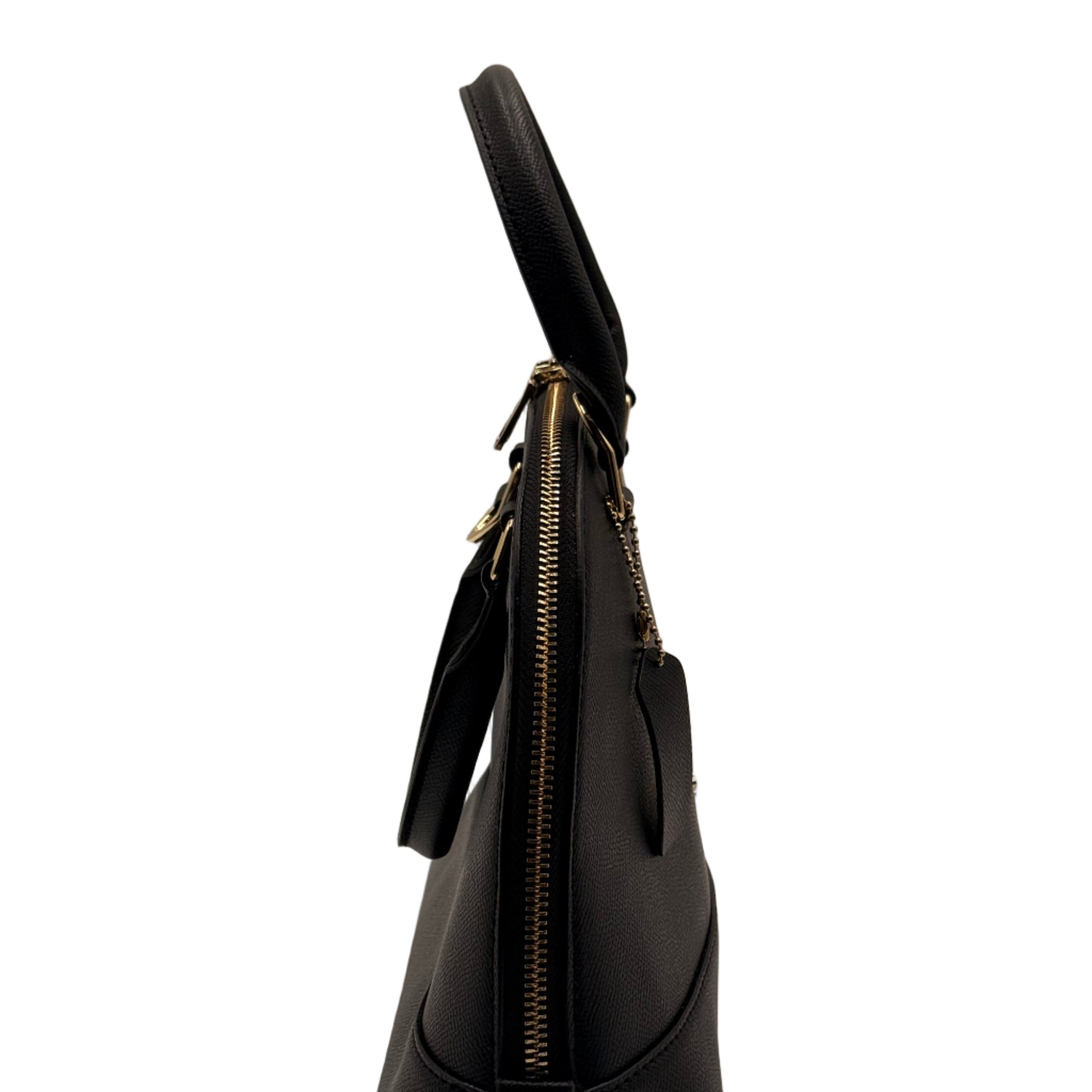 Black handbag with gold zipper on a light gray background