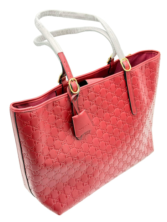 Red handbag with gold accents on a white background