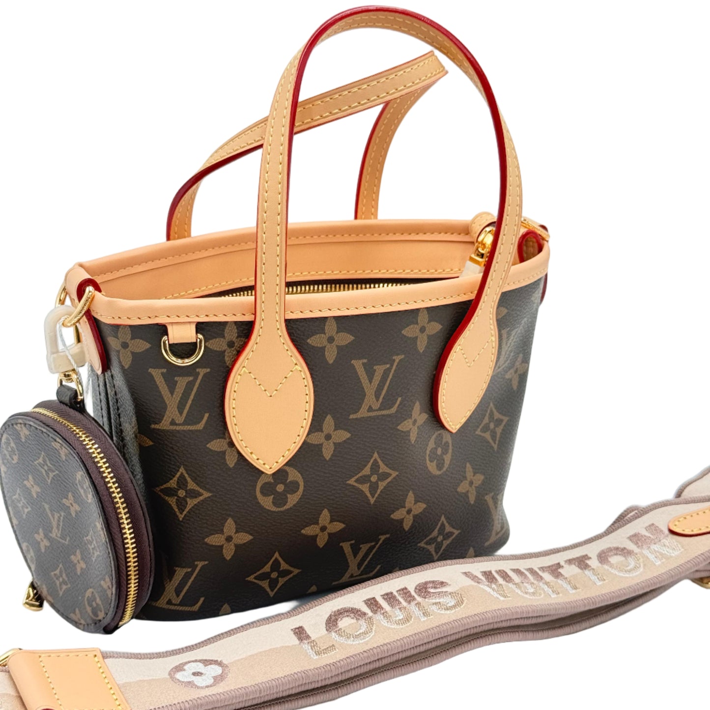 Louis Vuitton handbag with monogram pattern and tan leather accents on a light blue background