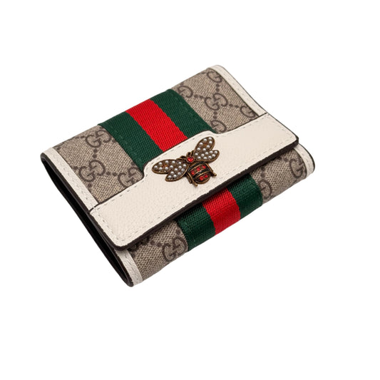 Designer wallet with brand logo and color stripes on a light gray background