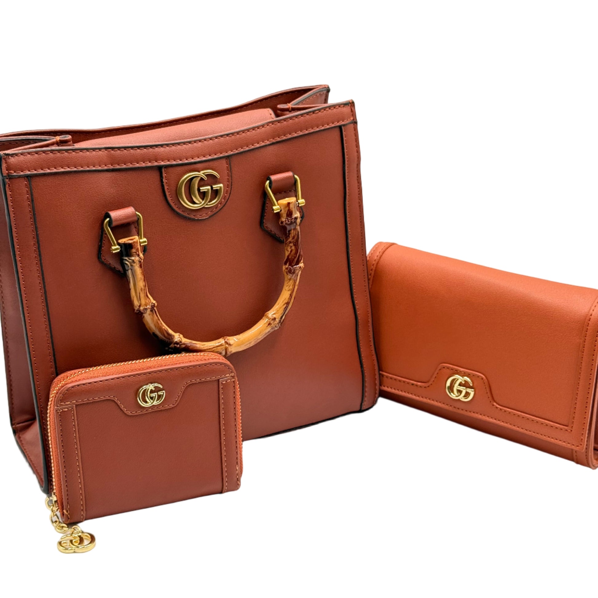 Brown leather handbag with gold hardware on a light gray background