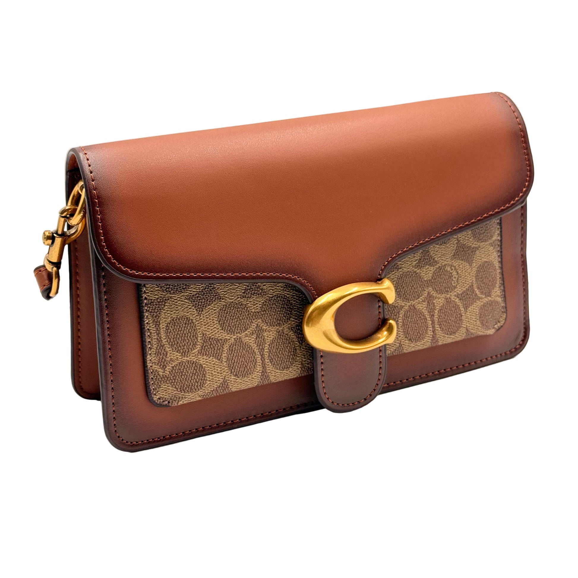 Brown leather handbag with gold accents on a light gray background