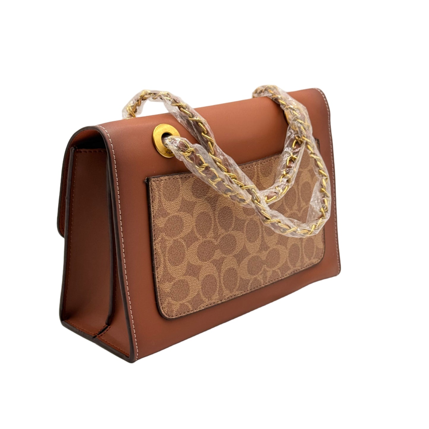 Brown handbag with patterned strap on a light gray background
