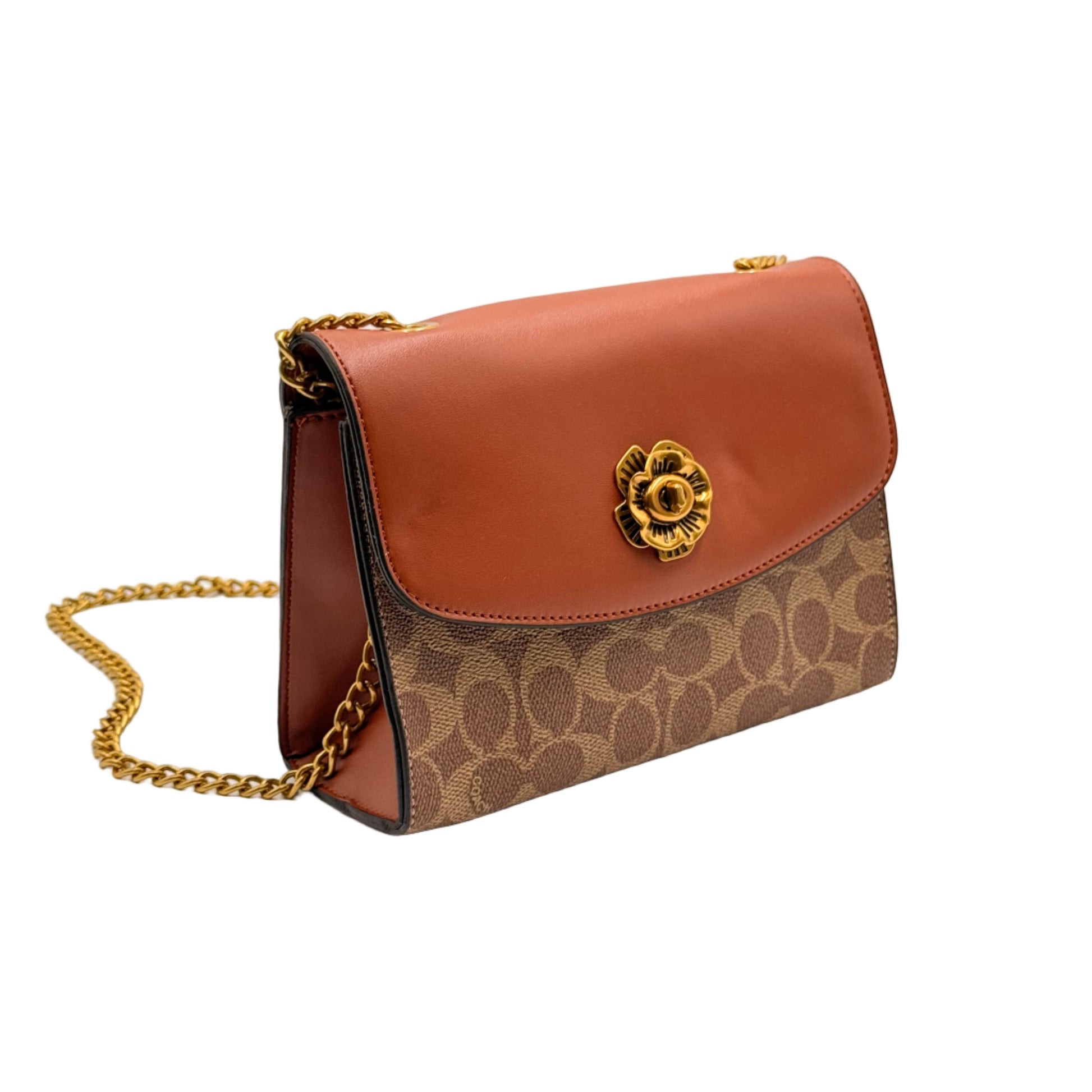 Brown handbag with gold chain and logo on a light gray background
