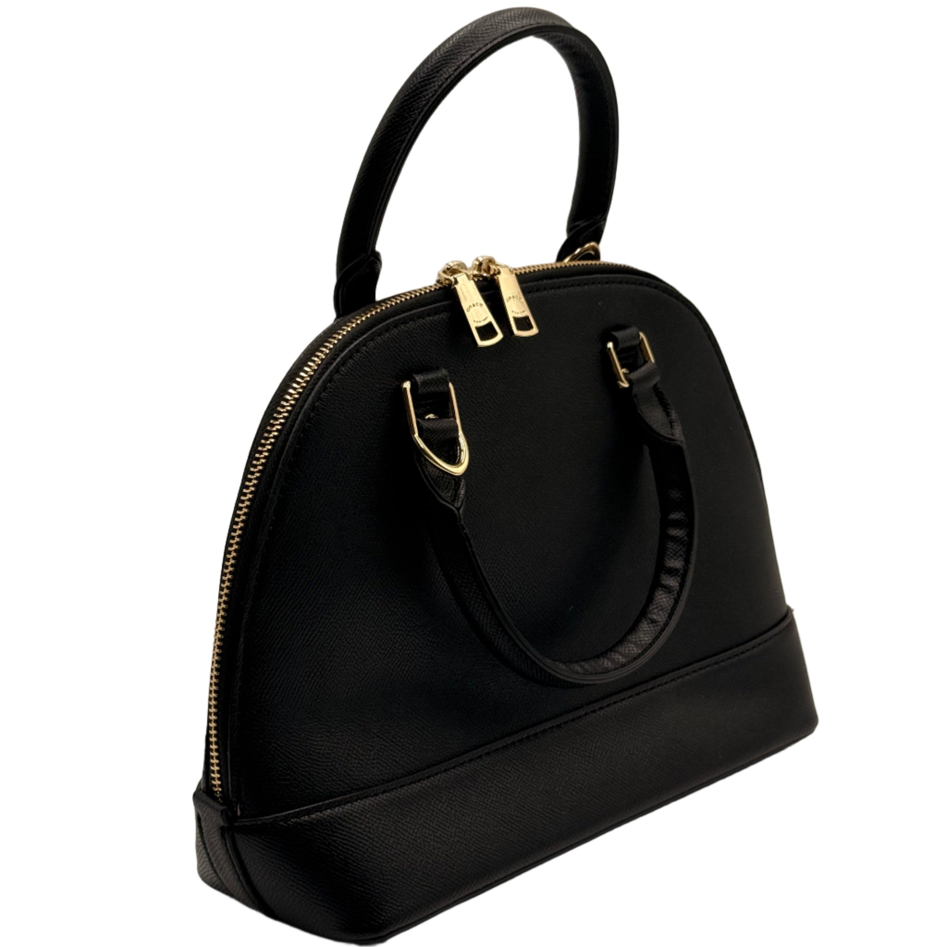 Black handbag with gold zippers on a light gray background