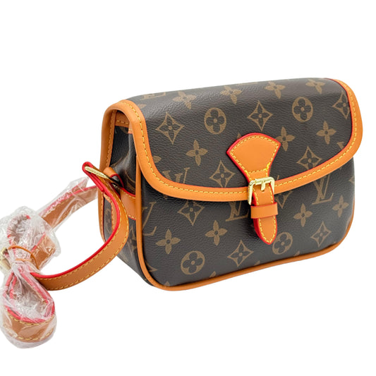 Designer handbag with monogram pattern on a light gray background